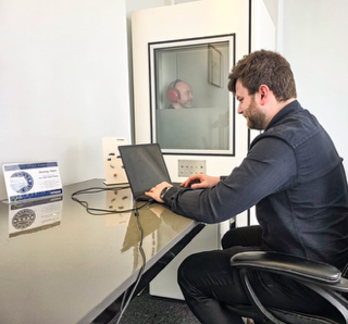 HCPC-registered audiologist carrying out a hearing test in Swansea
